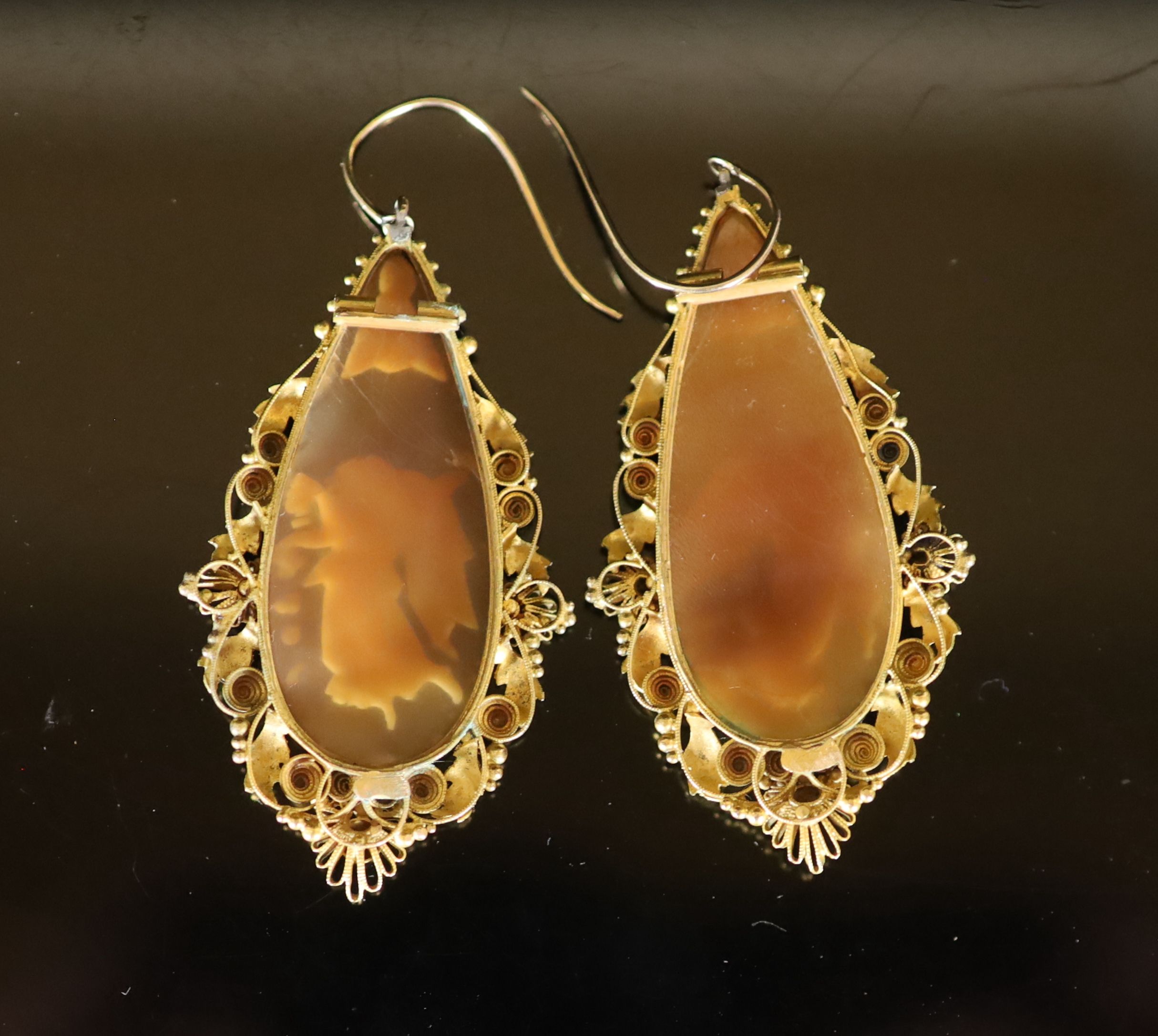 A pair of Victorian gold mounted cameo shell teardrop shaped drop earrings